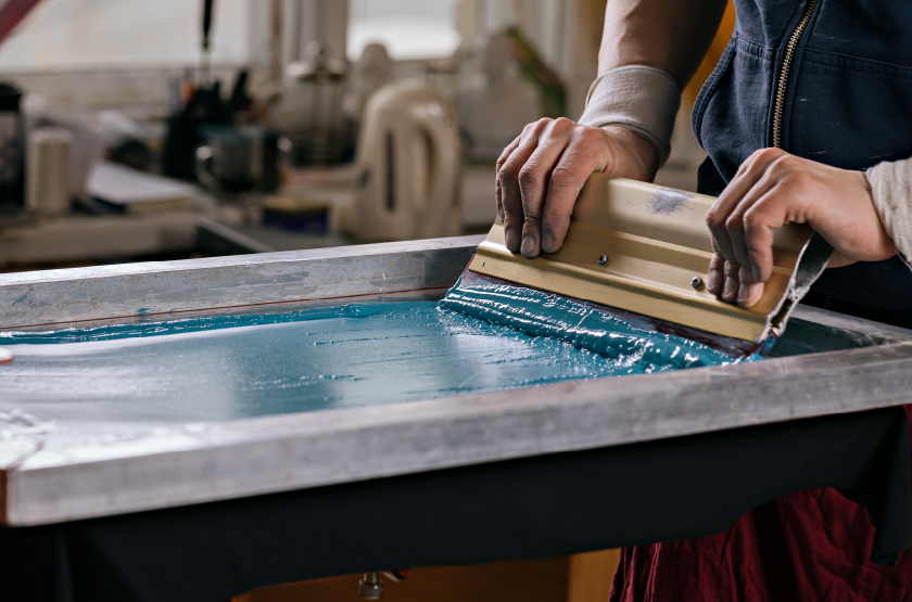 blue ink being pushed through a screen