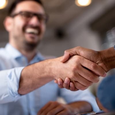 imgs_resources_warranty smiling man shaking a hand