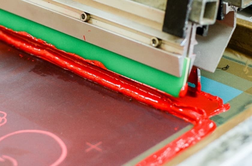 red ink being used on a screen print 