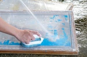 mesh screen being washed with a brush 