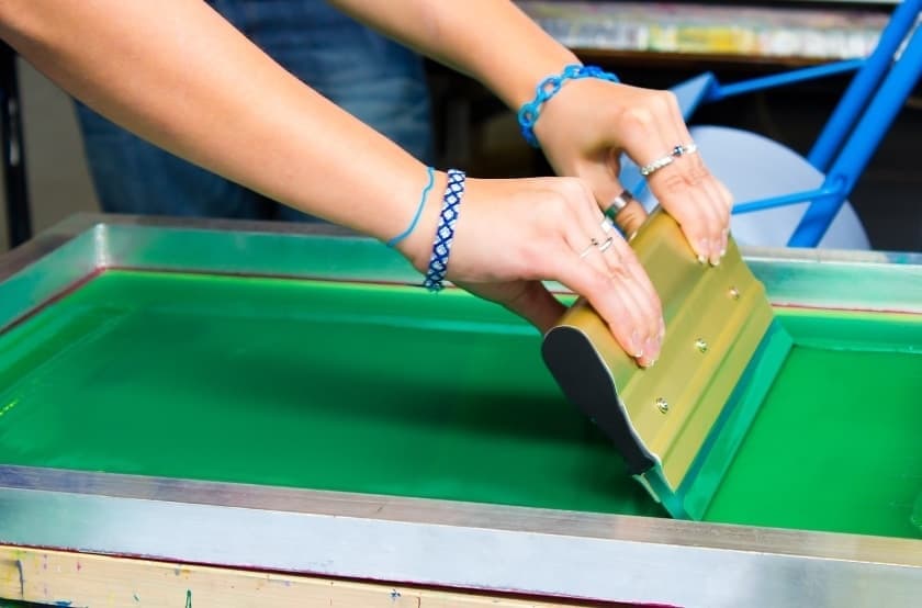 ink being pushed on a screen print transfer 