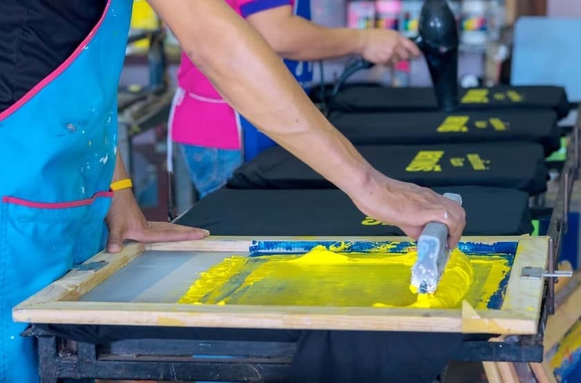 multiple t-shirt being produced on a press