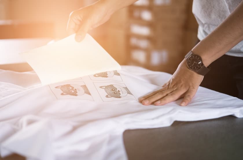 screen print transfer being removed on a white t-shirt 