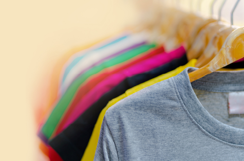 t-shirts on hangers on a rack 